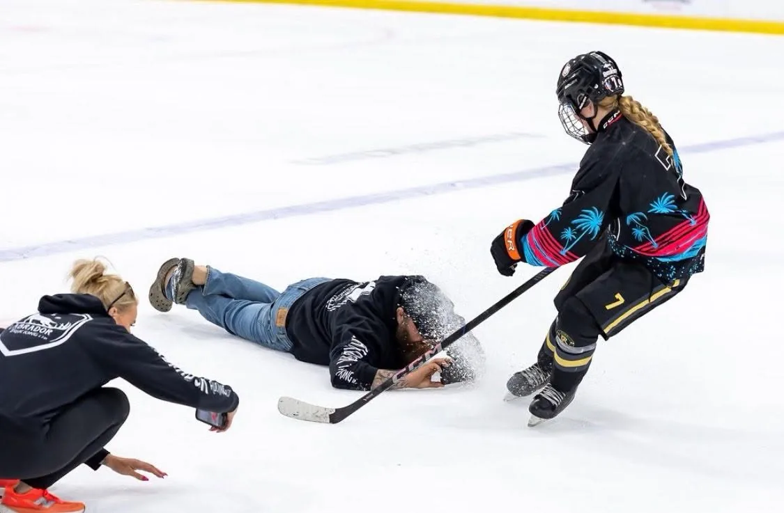 Labrador Trucking crew sharing a lighthearted moment on the ice with a hockey player