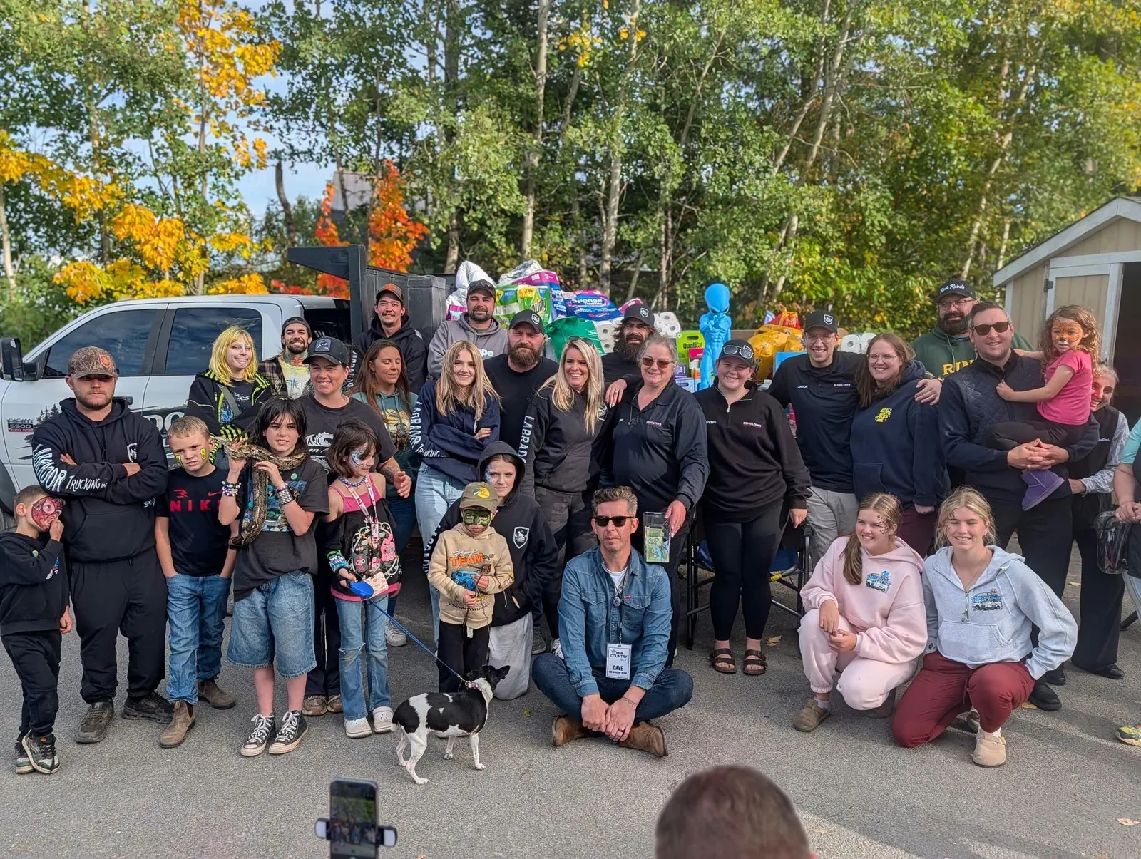 Labrador Trucking and community members gathered beside a truck loaded with pet supplies for the SPCA