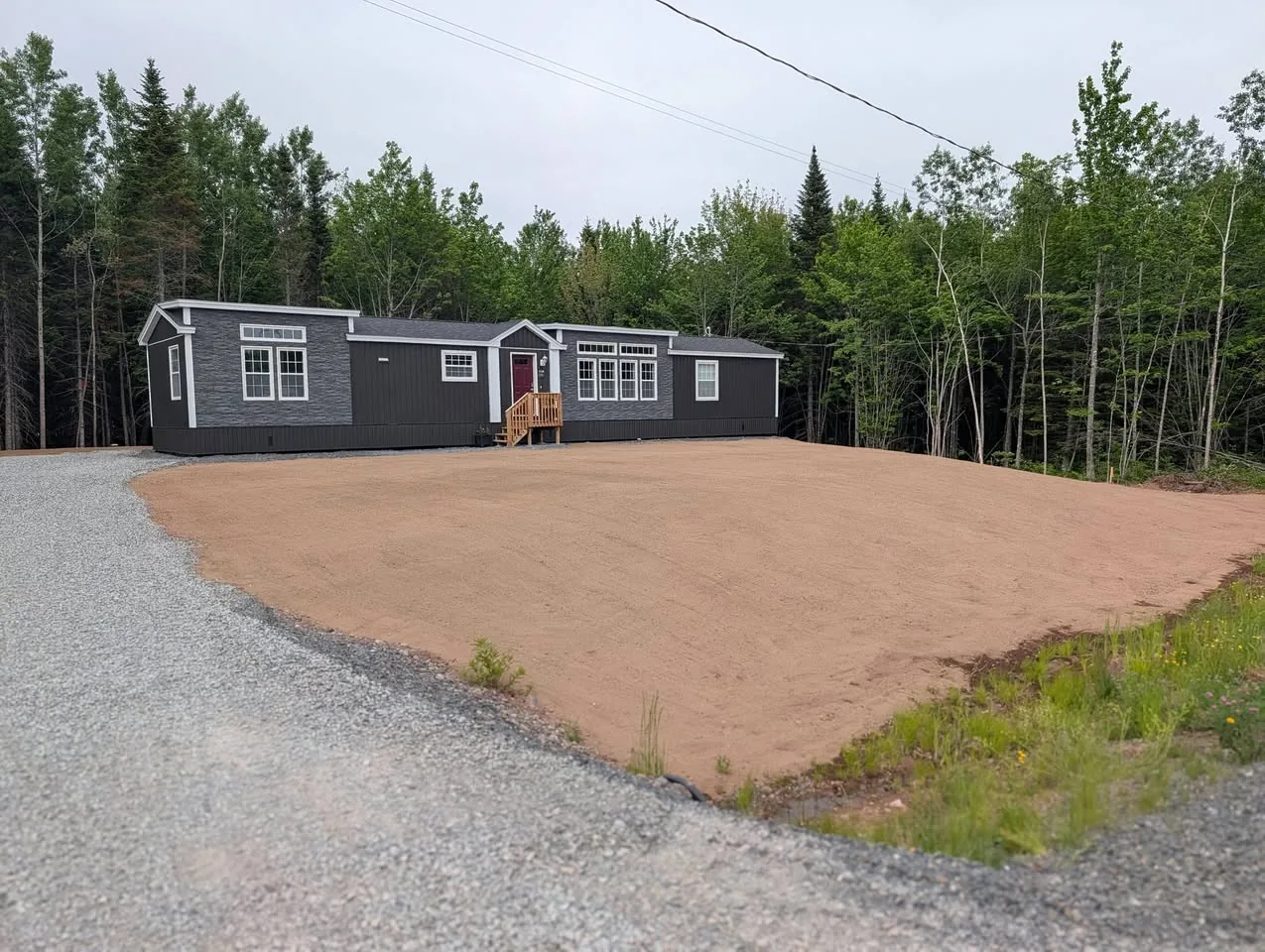 Waasis property with topsoil spread and the lawn area prepared for hydroseeding